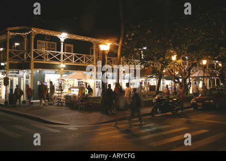 Shoppers head out into evening to enjoy stores, art galleries & restaurants along Front street historic downtown Lahiana, Maui Stock Photo