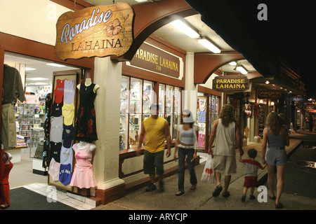 Shoppers head out into evening to enjoy stores, art galleries & restaurants along Front street historic downtown Lahiana, Maui Stock Photo