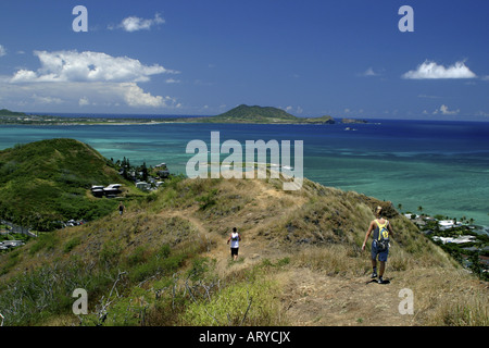 Hikers enjoy a spectacular view of Kailua Bay and Lanikai beach from the Lanikai ridge trail.Windward Oahu. Stock Photo