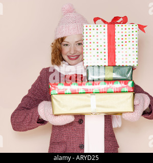 Woman holding stack of presents Stock Photo