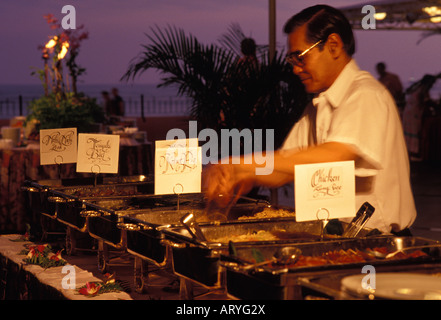 Food service worker preparing for the luau at the Sheraton Royal Hawaiian Hotel in Waikiki Stock Photo