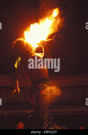 Man performing Polynesian fire eating, the entertainment at a luau, Sheraton Royal Hawaiian Hotel, Waikiki, Oahu Stock Photo