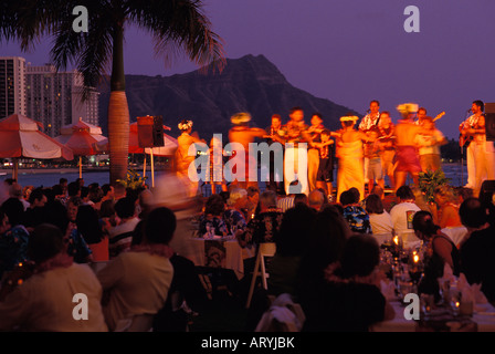 Polynesian revue at the Royal Hawaiian Hotel luau, with Diamond Head in the background Stock Photo