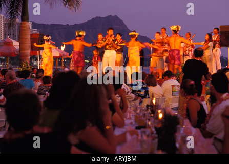 Polynesian revue at the Royal Hawaiian Hotel luau, with Diamond Head in the background Stock Photo