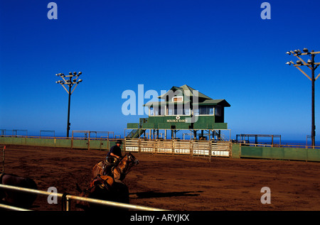 The Paniolo Rodeo Arena with a man riding a horse on Molokai Ranch Stock Photo