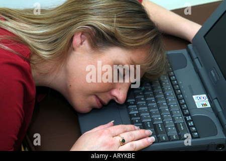 woman laying on laptop computer keyboard Stock Photo