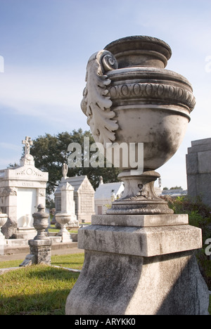 A marble urn in Metairie Cemetery faces a row of above-ground tombs.  New Orleans, Louisiana, USA. Stock Photo