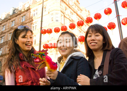 Three women on the streets of London in Chinatown to celebrate the Chinese New Year 2008 - Year of the rat Stock Photo