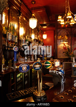 Beer tap with four different brands of beer in typical British pub interior the Salisbury London UK Stock Photo