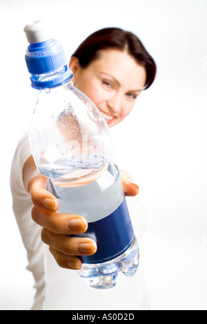 Thirsty. Cute teenager holding a bottle of water in the city smiling. Teen  girl, woman laughing happy about to drink water, posing touching hair city  Stock Photo - Alamy