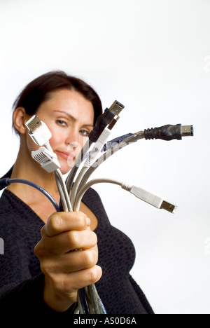 woman holding a bunch of computer wires and connectors Stock Photo