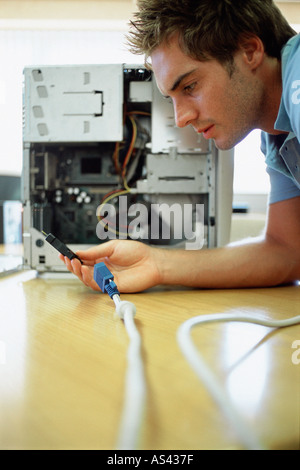 Man looking at a broken computer Stock Photo