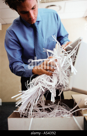 Man emptying shredder bin Stock Photo