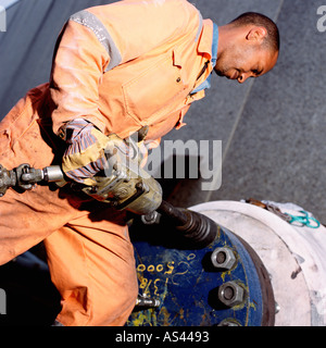 Construction worker using pneumatic drill Stock Photo