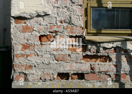 damaged plaster on building corner Stock Photo