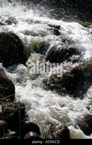 Stream Between Two Rocks The water moving in between the rocks at a wild beach in Atacama Desert ...