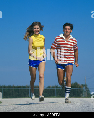 young couple jogging on running track Stock Photo