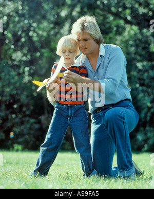 father and son playing with toy glider Stock Photo
