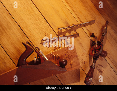 wood working tools on a work bench. Hand drill, bits and jack plane Stock Photo