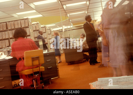 a busy corporate office scene with lots of people and motion Stock Photo