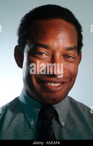 A black businessman in shirt sleeves and tie smiling Stock Photo