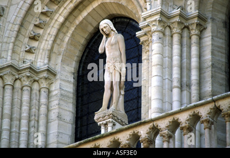 a statue in the window of notre dame in paris france Stock Photo