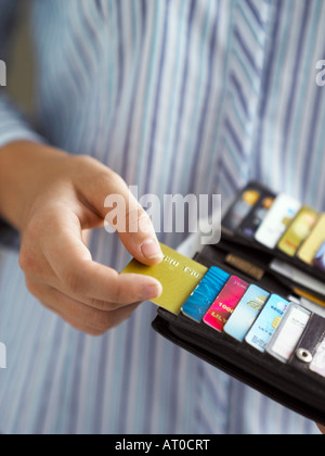 close up on woman taking credit card out of her purse Stock Photo