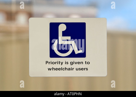 Vertical close up of a disabled sign on the window of public transport. Stock Photo