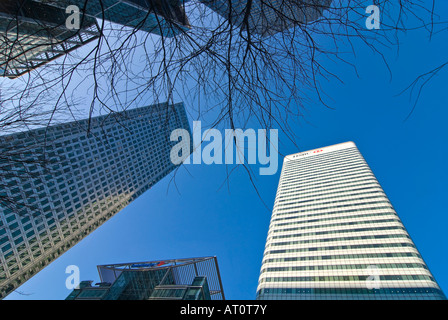 Horizontal wide angle of Canary Wharf tower and the surrounding skyscrapers in the redeveloped Docklands against a blue sky Stock Photo