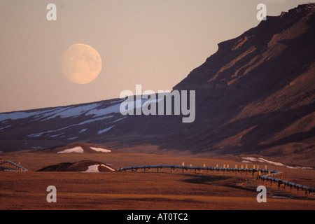 Alaskan pipeline with a full moon over the North Slope of the Brooks Range central Arctic of Alaska Stock Photo