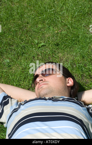 Man laying in the park Stock Photo