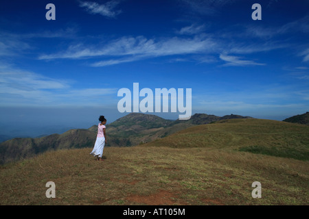 A young lady enjoying the beauty of the meadows. Stock Photo