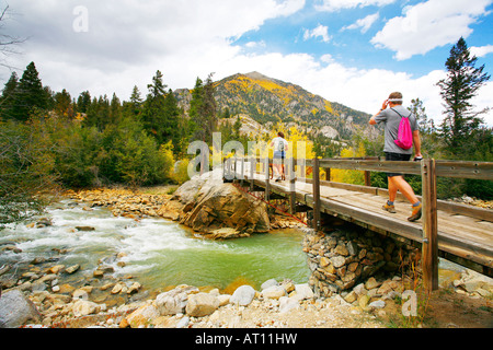 Hikers on bridge, Roaring Fork river, San Isabel National Forest, Colorado Stock Photo