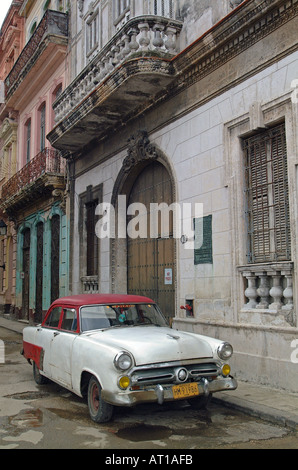 Old vintage American Ford car in front of building in Havana, Cuba. JMH0076 Stock Photo