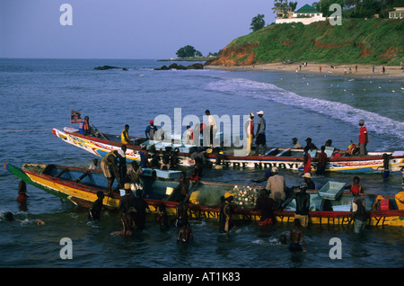 Fishermen and fishing boats on the beach of the Atlantic Ocean Bakau The Gambia West Africa Stock Photo