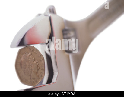 A spanner and fifty pence piece Stock Photo