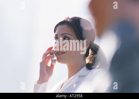 Hispanic woman talking on cellphone outdoors Stock Photo