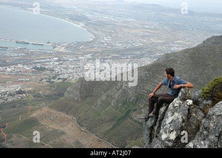 Solitary man looking over cape town from summit of Table Mountain South Africa Stock Photo