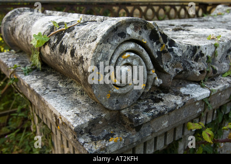 Ornate moss-covered tombstone Stock Photo