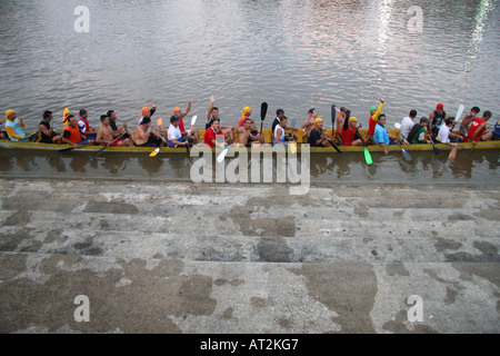 A Dragon boat crew training on the river, Sungai Sarawak, in Kuching, Sarawak, Borneo, Malaysia Stock Photo