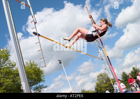 High school girl attempting a pole vault in a track and field meet Stock Photo