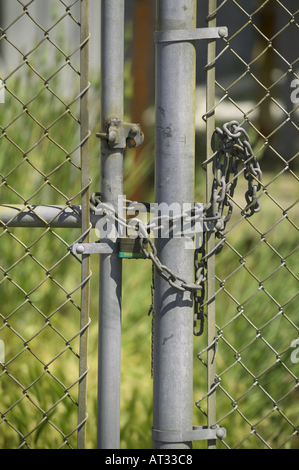 chained and locked abandoned factory Chain link Fence Stock Photo