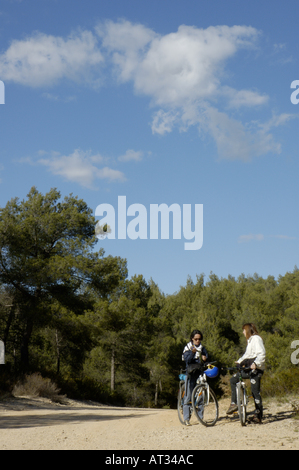 France Provence Vitrolles Two Women With Their Mountain Bikes On A Dirt Road Talking Stock Photo