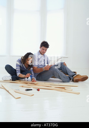 A man and woman assembling flat pack furniture Stock Photo