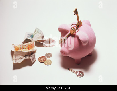 A pink piggy bank with money and keys