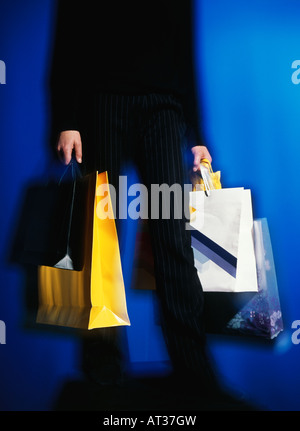 A man carrying shopping bags Stock Photo