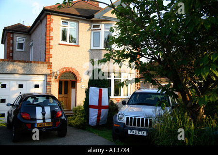 England flag hanging from bush in driveway, World Cup 2006, Wickford, Essex Stock Photo