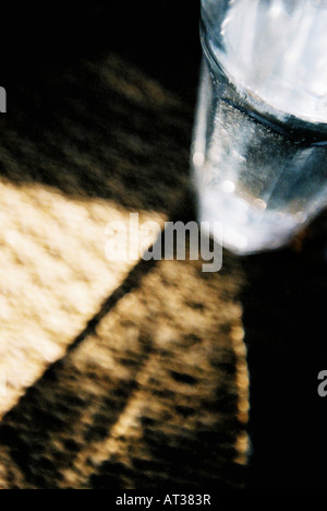 Glass of clean mineral sparkling water with ice and lemon on a white ...