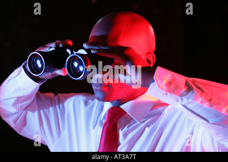 A man looking through binoculars Stock Photo