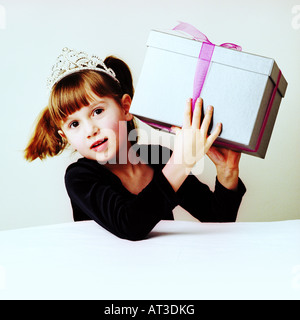 A girl shaking a present Stock Photo